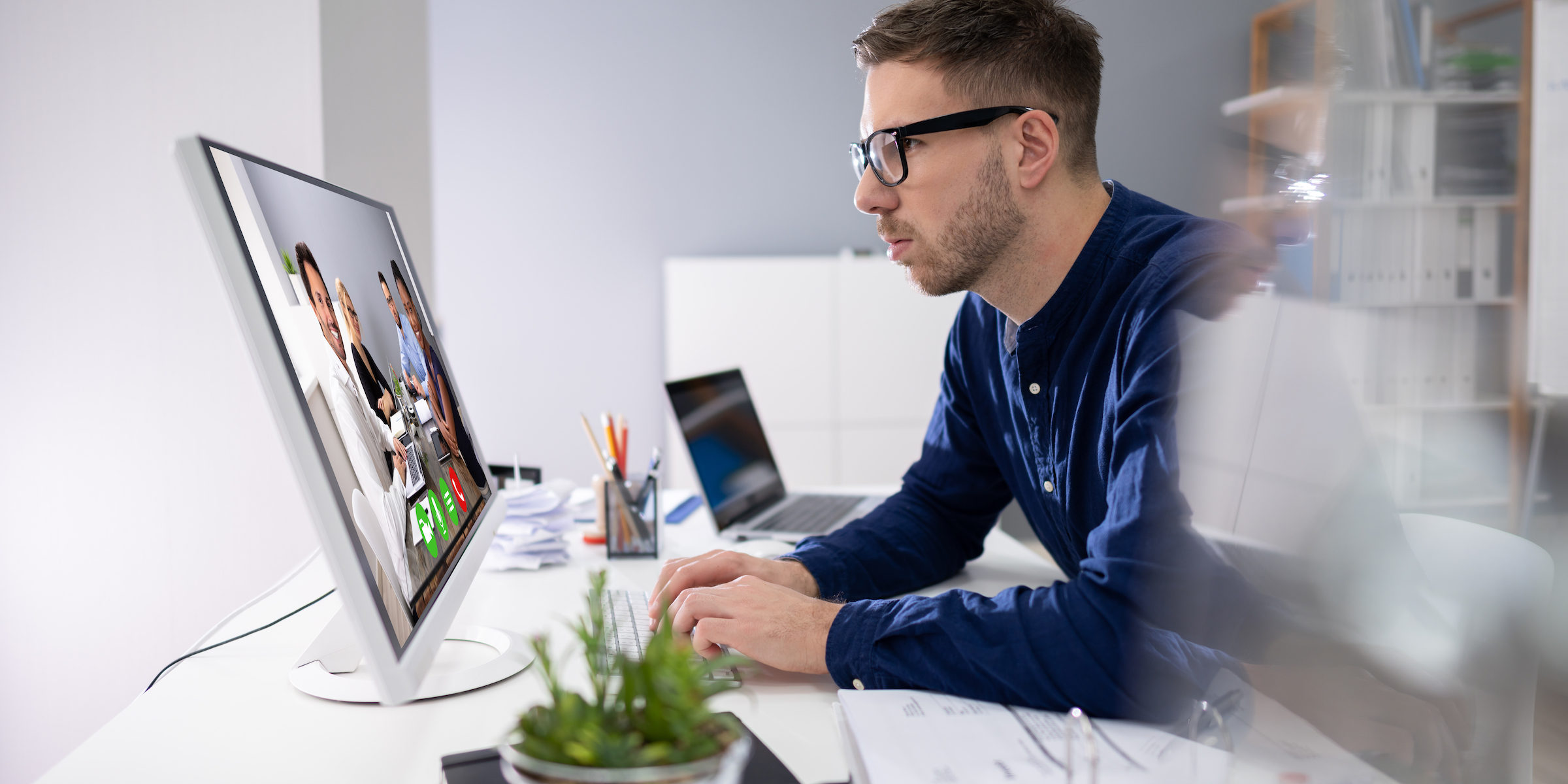 Businessman video conferencing at his computer