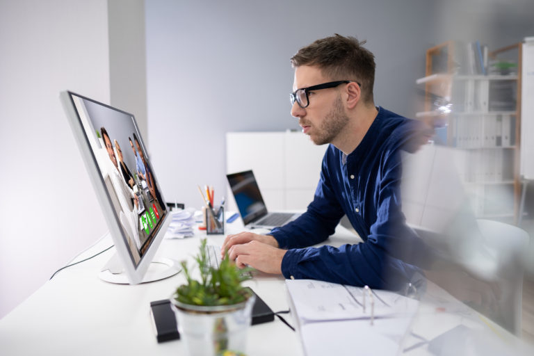 Businessman video conferencing at his computer