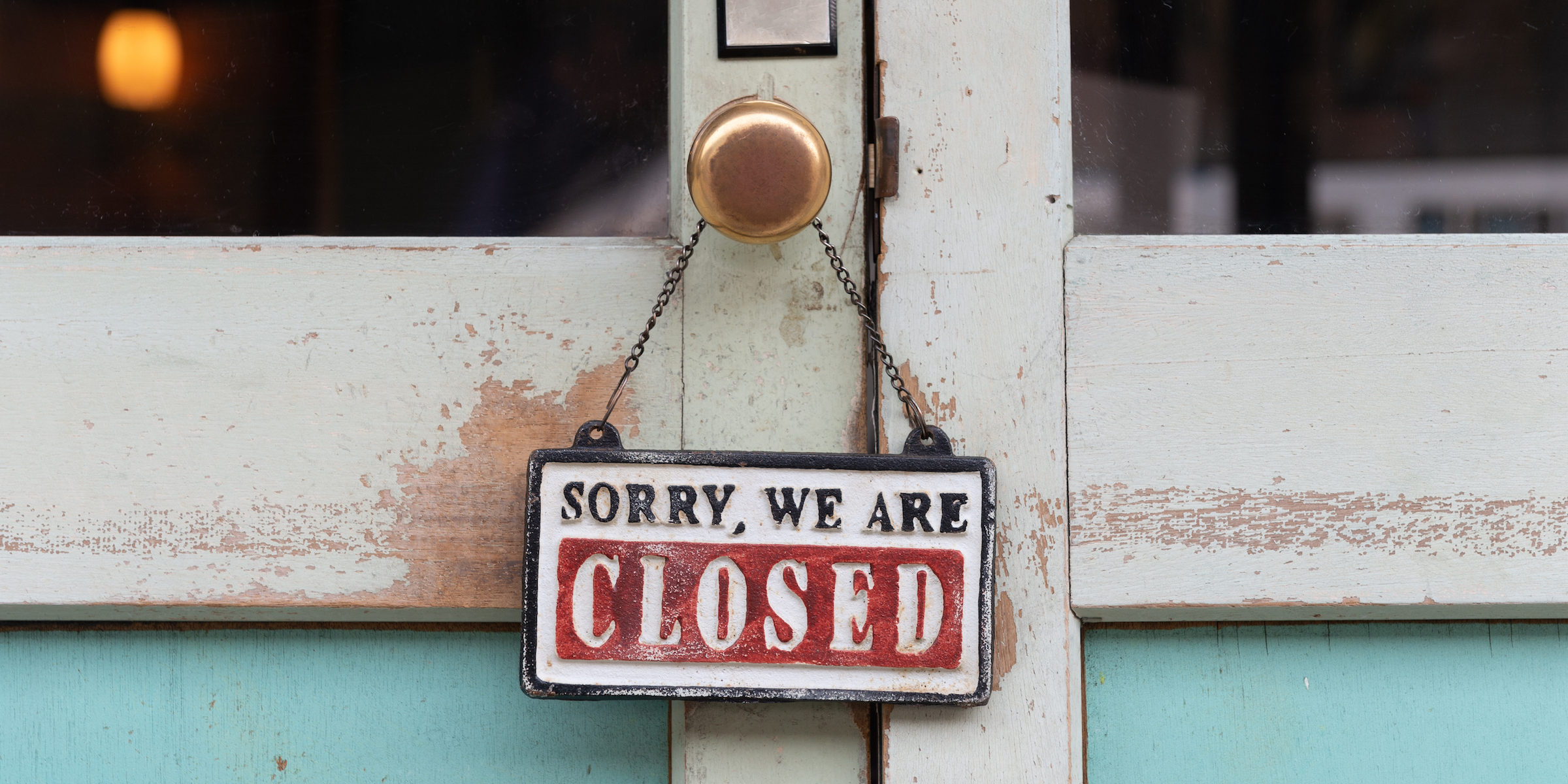 Sign on door saying Sorry, We are CLOSED